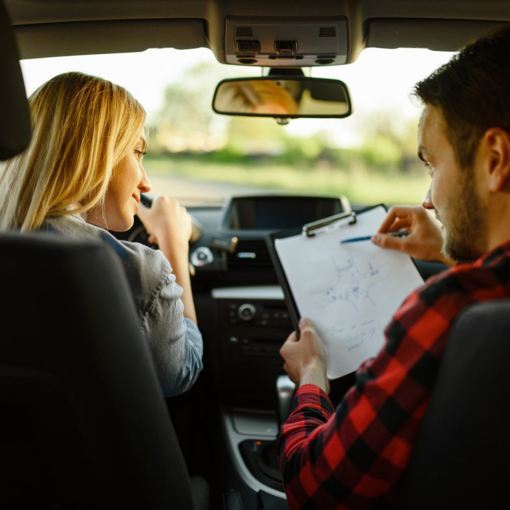 instructor-helps-woman-to-drive-the-car.jpg